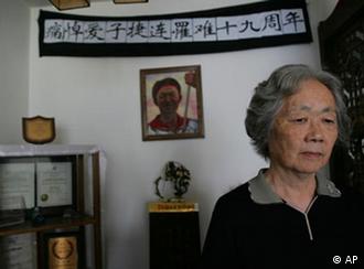 Ding Zilin, co-founder of the Tiananmen Mothers, a group representing families of those who died in the 1989 crackdown on pro-democracy demonstrations, stands in front of a shrine to her son, Jiang Jielian, at her apartment in Beijing Wednesday June 4, 2008. Wednesday is the 19th anniversary of the military assault in which hundreds, possibly thousands, were killed as Chinese troops shot their way through the city to end weeks of protests in Tiananmen Square. (AP Photo/Greg Baker)