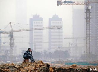 A worker rests on a construction site of a real estate project in Guangzhou, in south China's Guangdong province, Wednesday, Jan. 20, 2010. China's economic growth accelerated to 10.7 percent in the final quarter of 2009, adding to pressure on Beijing to cool inflation pressures while keeping the country's recovery on track. (AP Photo) ** CHINA OUT **