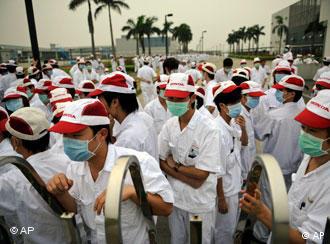 In this photo taken on May 26, 2010, employees at a Honda supply plant in Foshan gather near the factory gate during a strike in south China's Guangdong province. Honda Motor Co. says striking workers who have frozen production at its car plants in southern China have accepted a 24 percent wage increase, possibly allowing operations to resume this week. (AP Photo) ** CHINA OUT **