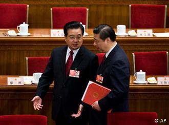 FILE - In this March 13, 2009 file photo, Chinese President Hu Jintao, left, chats with Vice President Xi Jinping as they leave the Great Hall of the People after the closing ceremony of the National People's Congress in Beijing, China. Chinese Vice President Xi has been promoted to vice chairman of a key Communist Party military committee, state media reported Monday, Oct. 18, 2010, in the clearest sign yet he is on track to be the country's future leader. (AP Photo/Andy Wong, File)