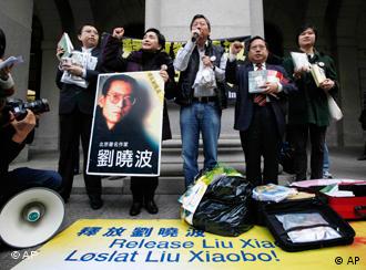 Pro-democracy lawmakers Albert Ho, second right, Lee Cheuk-yan, center, and Emily Lau, second left, meet the media as Lau holds a picture of jailed Nobel Peace Prize winner Chinese dissident Liu Xiaobo outside the Legislative Council in Hong Kong Wednesday, Dec. 8, 2010 before heading the Nobel Peace Prize Ceremony in Oslo. Since Liu's selection, China has vilified the 54-year-old democracy advocate, called the choice an effort by the West to contain its rise, disparaged his supporters as "clowns," and launched a campaign to persuade countries not to attend Friday's ceremony. (AP Photo/Kin Cheung)