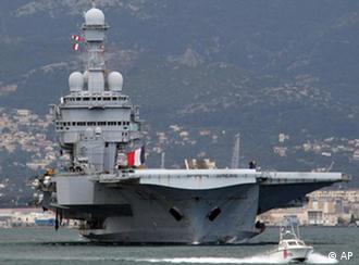 France's nuclear-powered aircraft carrier Charles de Gaulle leaves its home port of Toulon, southern France, Sunday, March 20, to the Mediterranean sea. Top officials from the United States, Europe and the Arab world have launched immediate military action to protect civilians as Libyan leader Moammar Gadhafi's forces attacked the heart of the country's rebel uprising . (AP Photo/Claude Paris)