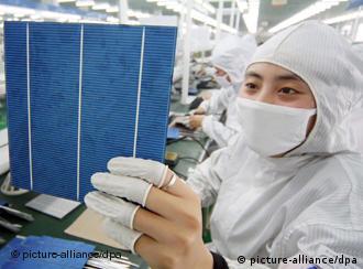 --FILE--Chinese workers manufacture photovoltaic cells of solar panels at the plant of Eoplly New Energy Technology Co., Ltd. in Nantong city, east Chinas Jiangsu province, 21 February 2011. The US on Wednesday (9 November 2011) opened an official investigation into whether imported Chinese solar cells were unfairly undercutting American products, the first such case in the renewable energy sector. The complaint alleges that solar cells from China are being dumped in the US, with normal prices between 50 per cent and 250 per cent higher than the export price. If the commerce department finds evidence of dumping or of unfair state subsidy, compensatory tariffs can be imposed on the Chinese imports. Photo: Xu Ruiping/Imaginechina 