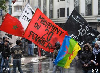 Anti-government protesters hold the Moroccan national flag, left, and the 20th February movement flag in red black and white during a rally organized by the 20th February, the Moroccan Arab Spring movement in Casablanca, Morocco, Sunday, Nov 20, 2011 Copyright: AP Photo/Abdeljalil Bounhar